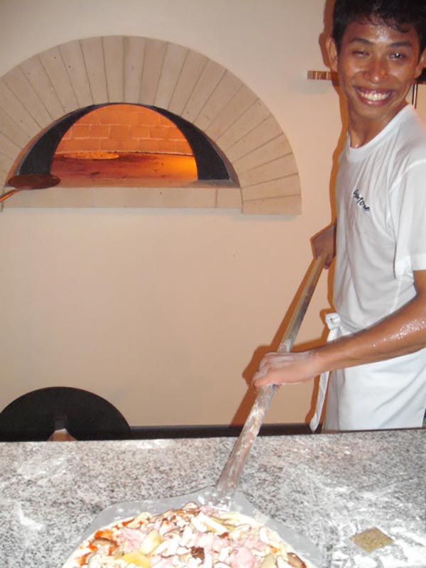 Modern pizza oven in action in Kata Beach